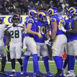 
              Los Angeles Rams wide receiver Cooper Kupp (10) celebrates his touchdown catch with teammates during the second half of an NFL football game against the Seattle Seahawks on Tuesday, Dec. 21, 2021, in Inglewood, Calif. (AP Photo/Kevork Djansezian)
            