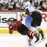 
              Vegas Golden Knights defenseman Zach Whitecloud (2) checks New Jersey Devils center Jack Hughes (86) to the ice during the third period of an NHL hockey game Thursday, Dec.16, 2021, in Newark, N.J. (AP Photo/Bill Kostroun)
            