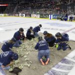 
              Local teachers scramble for dollar bills to fund projects for their classrooms on Saturday, Dec. 11, 2021, in the first-ever Dash For Cash between periods at the Sioux Falls Stampede game in Sioux Falls, S.D. The organizers of the fundraiser are apologizing after the event was criticized as demeaning. (Erin Woodiel/The Argus Leader via AP)
            