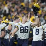
              Michigan tight end Luke Schoonmaker (86) celebrates with teammates at the end of the Big Ten championship NCAA college football game against Iowa, Saturday, Dec. 4, 2021, in Indianapolis. Michigan won 42-3. (AP Photo/Darron Cummings)
            