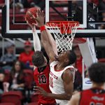 
              Texas Tech's Bryson Williams (11) blocks the shot by Eastern Washington's Ethan Price (10) during the first half of an NCAA college basketball game on Wednesday, Dec. 22, 2021, in Lubbock, Texas. (AP Photo/Brad Tollefson)
            