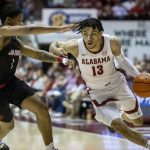 
              Alabama guard Jahvon Quinerly (13) drives inside against Jacksonville State guard Demaree King (1) during the first half of an NCAA college basketball game, Saturday, Dec. 18, 2021, in Tuscaloosa, Ala. (AP Photo/Vasha Hunt)
            