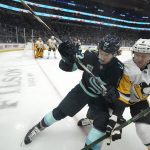 
              Seattle Kraken center Mason Appleton, left, and Pittsburgh Penguins defenseman Chad Ruhwedel, right, go up against the boards during the first period of an NHL hockey game, Monday, Dec. 6, 2021, in Seattle. (AP Photo/Ted S. Warren)
            
