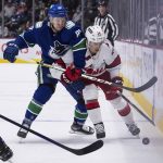 
              Vancouver Canucks' Juho Lammikko, left, of Finland, and Carolina Hurricanes' Seth Jarvis vie for the puck during the second period of an NHL hockey game in Vancouver, British Columbia, Sunday, Dec. 12, 2021. (Darryl Dyck/The Canadian Press via AP)
            