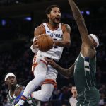 
              New York Knicks guard Derrick Rose (4) drives to the basket against Milwaukee Bucks center DeMarcus Cousins, right, during the first half of an NBA basketball game in New York, Sunday, Dec. 12, 2021. (AP Photo/Noah K. Murray)
            