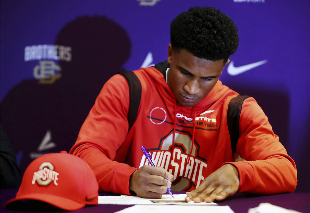 Ohio State University commit Dallan Hayden signs his letter of intent during a signing day event at...