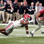 
              Alabama quarterback Bryce Young (9) run s past Georgia defensive lineman Jalen Carter (88) for a touchdown during the first half of the Southeastern Conference championship NCAA college football game, Saturday, Dec. 4, 2021, in Atlanta. (AP Photo/Brynn Anderson)
            