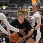 
              Pacific guard Josephine Millard, center, is defended by Stanford forward Francesca Belibi, left and guard Lexie Hull during the first half of an NCAA college basketball game in Stanford, Calif., Sunday, Dec. 12, 2021. (AP Photo/Jeff Chiu)
            