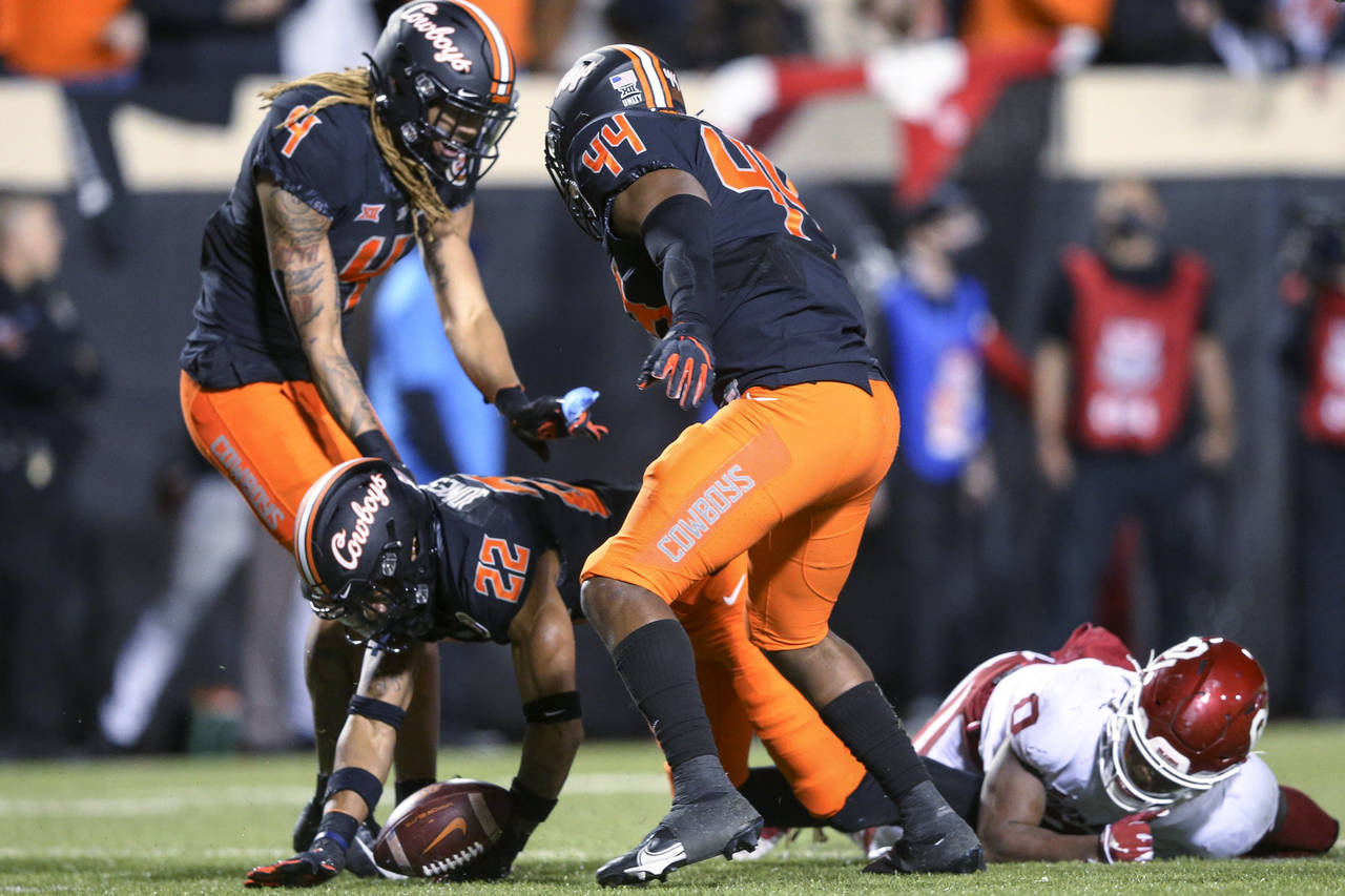Oklahoma State's Korie Black (4) and Kamryn Farrar (44) celebrate after Demarco Jones (22) recovere...
