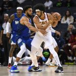 
              Minnesota Timberwolves center Karl-Anthony Towns, left, defends against Cleveland Cavaliers center Jarrett Allen during the first half of an NBA basketball game Friday, Dec. 10, 2021, in Minneapolis. (AP Photo/Craig Lassig)
            