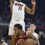 
              Cleveland Cavaliers' Evan Mobley (4) drives against Miami Heat's KZ Okpala (11) in the first half of an NBA basketball game, Monday, Dec. 13, 2021, in Cleveland. (AP Photo/Tony Dejak)
            
