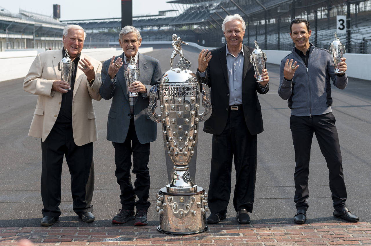 FILE - Winner of this year's Indy 500, Helio Castroneves, right, gathered with other four-time winn...