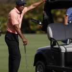 
              Tiger Woods watches play from his golf cart during the first round of the PNC Championship golf tournament Saturday, Dec. 18, 2021, in Orlando, Fla. (AP Photo/Scott Audette)
            