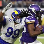 
              Minnesota Vikings running back Alexander Mattison (25) runs from Los Angeles Rams defensive end Aaron Donald (99) during the second half of an NFL football game, Sunday, Dec. 26, 2021, in Minneapolis. (AP Photo/Bruce Kluckhohn)
            