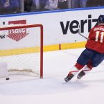 
              Florida Panthers left wing Jonathan Huberdeau (11) scores an empty-net goal during the third period of an NHL hockey game against the Buffalo Sabres, Thursday, Dec. 2, 2021, in Sunrise, Fla. (AP Photo/Wilfredo Lee)
            