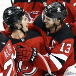 
              New Jersey Devils' Jack Hughes celebrates with Nico Hischier (13) after Hughes scored the winning goal during the overtime period of an NHL hockey game against the Edmonton Oilers, Friday, Dec. 31, 2021, in Newark, N.J. (AP Photo/Bill Kostroun)
            