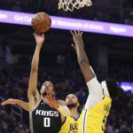 
              Sacramento Kings guard Tyrese Haliburton (0) shoots against Golden State Warriors forward Kevon Looney (5) during the first half of an NBA basketball game in San Francisco, Monday, Dec. 20, 2021. (AP Photo/Jed Jacobsohn)
            