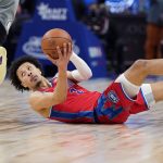 
              Detroit Pistons guard Cade Cunningham passes the ball during the second half of an NBA basketball game against the Brooklyn Nets, Sunday, Dec. 12, 2021, in Detroit. (AP Photo/Carlos Osorio)
            