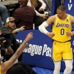 
              Los Angeles Lakers' Russell Westbrook (0) celebrates after sinking a basket as fans look on in the second half of an NBA basketball game in Dallas, Wednesday, Dec. 15, 2021. (AP Photo/Tony Gutierrez)
            