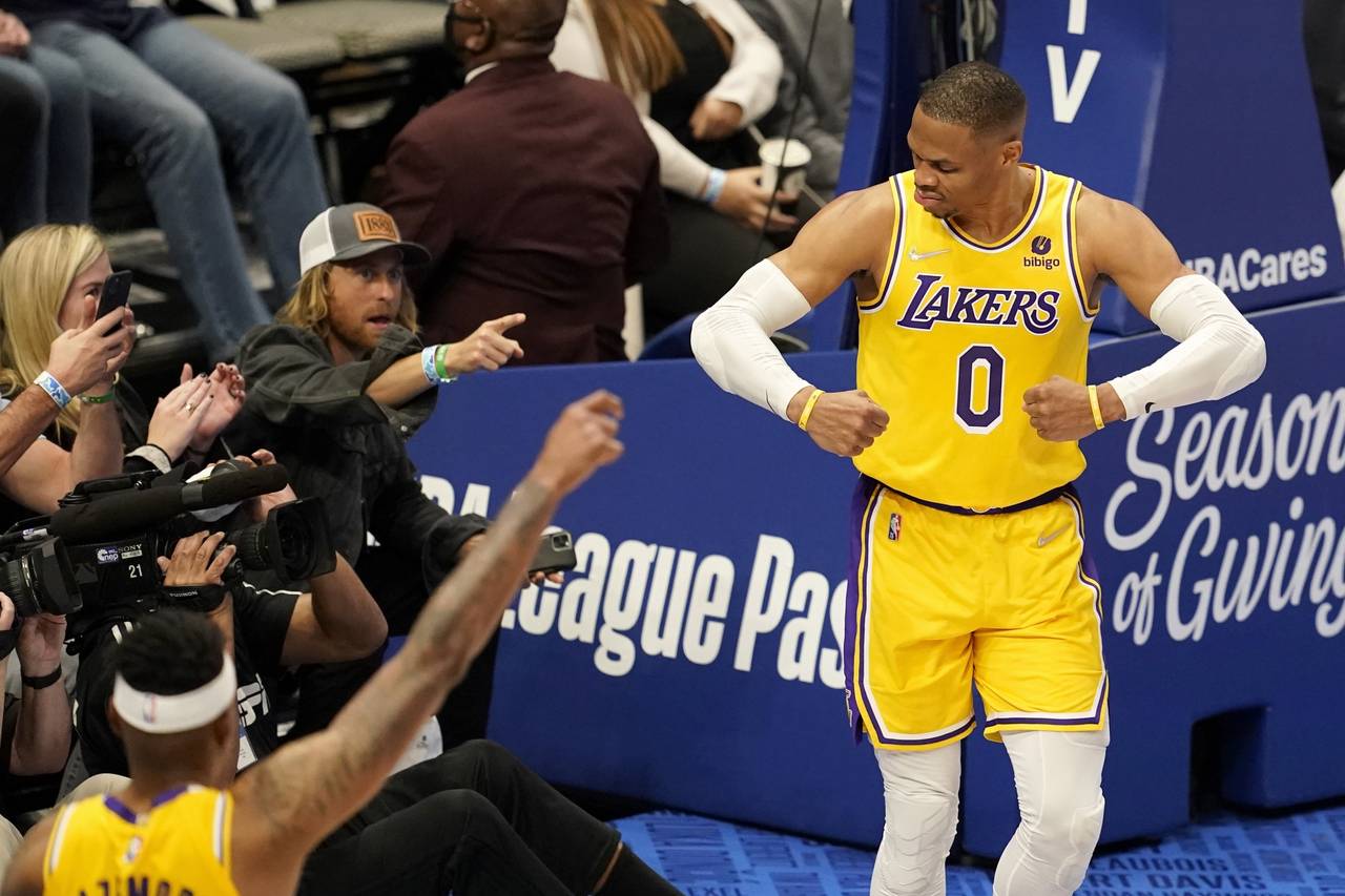 Los Angeles Lakers' Russell Westbrook (0) celebrates after sinking a basket as fans look on in the ...