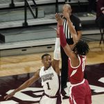 
              Arkansas guard Stanley Umude (0) shoots over Mississippi State guard Iverson Molinar (1) during the first half of an NCAA college basketball game in Starkville, Miss., Wednesday, Dec. 29, 2021. (AP Photo/Rogelio V. Solis)
            