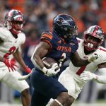 
              UTSA running back Sincere McCormick (3) runs around Western Kentucky defensive back Antwon Kincade (1) during the first half of an NCAA college football game in the Conference USA Championship, Friday, Dec. 3, 2021, in San Antonio. (AP Photo/Eric Gay)
            