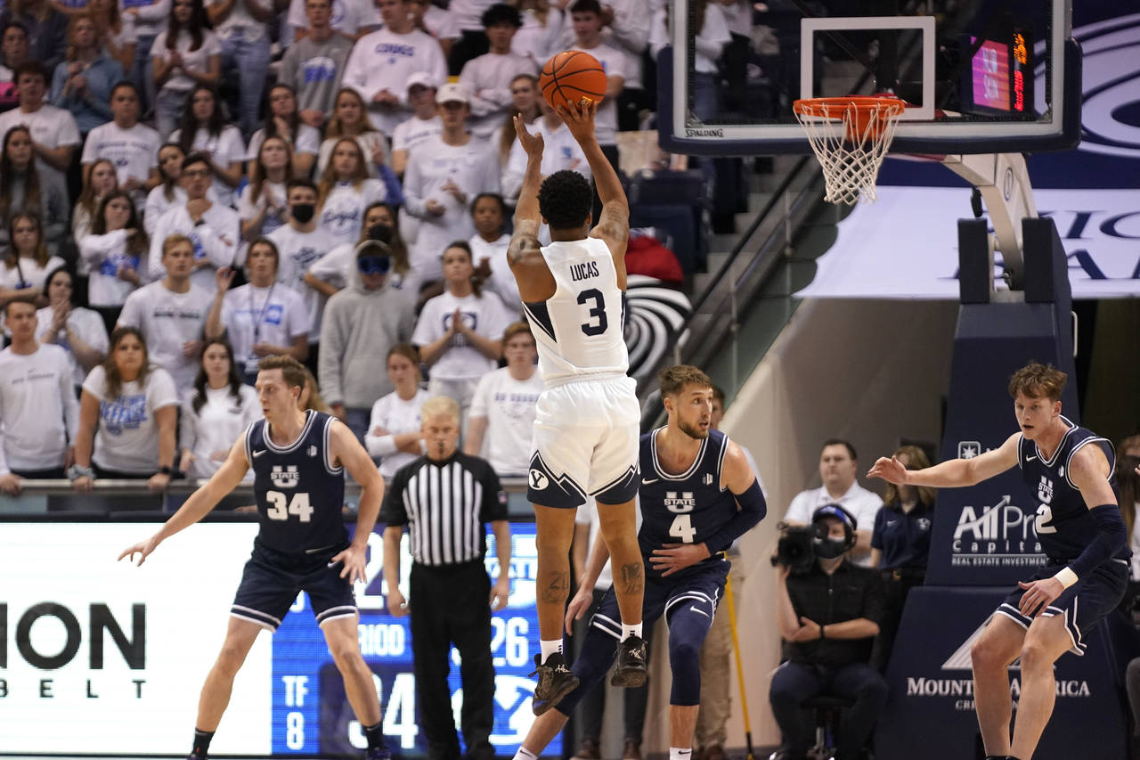 BYU guard Te'Jon Lucas (3) shoots against Utah State in the first half during an NCAA college baske...