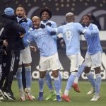 
              New York City FC players celebrate their penalty kick shootout win over the Portland Timbers in the MLS Cup soccer game, Saturday, Dec. 11, 2021, in Portland, Ore. (AP Photo/Amanda Loman)
            