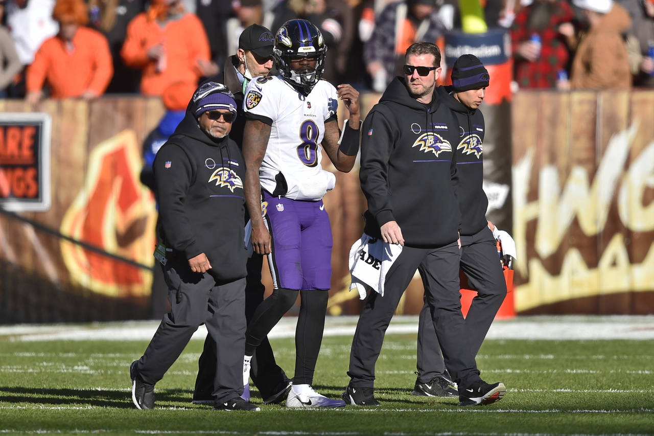 Baltimore Ravens quarterback Lamar Jackson (8) walks off the field with an injury during the first ...