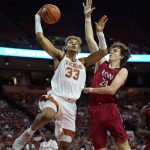 
              Texas forward Tre Mitchell (33) drives to the basket against Incarnate Word forward Benjamin Griscti (24) during the second half of an NCAA college basketball game, Tuesday, Dec. 28, 2021, in Austin, Texas. (AP Photo/Eric Gay)
            