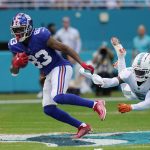
              New York Giants wide receiver Pharoh Cooper (83) evades a tackle by Miami Dolphins cornerback Noah Igbinoghene (9) during the first half of an NFL football game, Sunday, Dec. 5, 2021, in Miami Gardens, Fla. (AP Photo/Lynne Sladky)
            