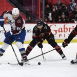 
              Ottawa Senators right wing Drake Batherson (19) and left wing Brady Tkachuk work to take the puck from Colorado Avalanche right wing Mikko Rantanen (96) during the third period of an NHL hockey game Saturday, Dec. 4, 2021, in Ottawa, Ontario. (Justin Tang/The Canadian Press via AP)
            