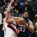 
              Minnesota Timberwolves center Karl-Anthony Towns, right, drives to the basket against Portland Trail Blazers forward Larry Nance Jr., left, during the first half of an NBA basketball game in Portland, Ore., Sunday, Dec. 12, 2021. (AP Photo/Steve Dipaola)
            