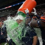 
              UTSA head coach Jeff Traylor, center, is doused by his players after the team's win over Western Kentucky in an NCAA college football game in the Conference USA Championship, Friday, Dec. 3, 2021, in San Antonio. (AP Photo/Eric Gay)
            