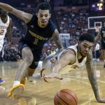 
              Texas center Timmy Allen, right, and Alabama State guard DJ Jackson, left, fight for a loose ball during the first half of an NCAA college basketball game, Wednesday, Dec. 22, 2021, in Austin, Texas. (AP Photo/Michael Thomas)
            
