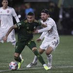 
              Portland Timbers midfielder Marvin Loria, front left, and Real Salt Lake midfielder Nick Beslern (13) compete for the ball during the first half of the MLS soccer Western Conference final Saturday, Dec. 4, 2021, in Portland, Ore. (AP Photo/Amanda Loman)
            