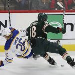 
              Minnesota Wild left wing Jordan Greenway (18) collides with Buffalo Sabres defenseman Rasmus Dahlin (26) during the first period of an NHL hockey game, Thursday, Dec. 16, 2021, in St. Paul, Minn. (AP Photo/Stacy Bengs)
            