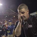 
              Louisiana-Lafayette head coach Billy Napier, soon to be Florida head coach, wipes his eye after the team defeated Appalachian State in the Sun Belt Conference championship NCAA college football game in Lafayette, La., Saturday, Dec. 4, 2021. (AP Photo/Matthew Hinton)
            