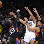 
              Golden State Warriors guard Stephen Curry (30) passes the ball away from Phoenix Suns forward Jae Crowder (99) and guard Devin Booker during the first half of an NBA basketball game Saturday, Dec. 25, 2021, in Phoenix. (AP Photo/Rick Scuteri)
            