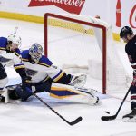 
              St. Louis Blues goaltender Jordan Binnington (50) and Justin Faulk (72) cover the net to make a save against Winnipeg Jets' Paul Stastny (25) during the second period of NHL hockey game action in Winnipeg, Manitoba, Sunday, Dec. 19, 2021. (Fred Greenslade/The Canadian Press via AP)
            