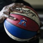 
              Former professional basketball player and Olympic gold medalist Spencer Haywood shows a signed ball from his American Basketball Association days at his Las Vegas home Monday, Nov. 29, 2021. (AP Photo/Ellen Schmidt)
            