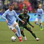 
              New York City FC defender Gudmundur Thorarinsson (20) dribbles the ball ahead of Portland Timbers midfielder Yimmi Chara (23) during the first half of the MLS Cup soccer match Saturday, Dec. 11, 2021, in Portland, Ore. (AP Photo/Amanda Loman)
            