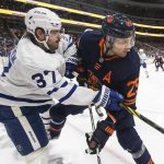 
              Toronto Maple Leafs' Timothy Liljegren (37) and Edmonton Oilers' Leon Draisaitl (29) battle for the puck during the second period of an NHL hockey game Tuesday, Dec. 14, 2021 in Edmonton, Alberta  (Jason Franson/The Canadian Press via AP)
            