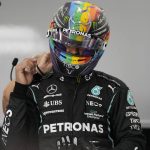 
              Mercedes driver Lewis Hamilton of Britain adjusts helmet during practice session for the Saudi Arabian Grand Prix in Jiddah, Friday, Dec. 3, 2021. (AP Photo/Hassan Ammar)
            