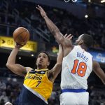 
              Indiana Pacers' Malcolm Brogdon (7) shoots against New York Knicks' Alec Burks (18) during the second half of an NBA basketball game Wednesday, Dec. 8, 2021, in Indianapolis. (AP Photo/Darron Cummings)
            
