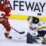 
              Boston Bruins goalie Linus Ullmark makes a save against Calgary Flames' Andrew Mangiapane during the second period of an NHL hockey game Saturday, Dec. 11, 2021, in Calgary, Alberta. (Larry MacDougal/The Canadian Press via AP)
            