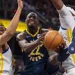 
              Indiana Pacers guard Caris LeVert (22) reacts as he drives the ball toward the basket through the Golden State Warriors defense during the second half of an NBA basketball game in Indianapolis, Monday, Dec. 13, 2021. (AP Photo/Doug McSchooler)
            