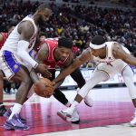 
              Chicago Bulls forward Alfonzo McKinnie, center, battles for the ball against Los Angeles Lakers forward LeBron James, front left, and guard Rajon Rondo during the second half of an NBA basketball game in Chicago, Sunday, Dec. 19, 2021. (AP Photo/Nam Y. Huh)
            