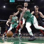 
              Boston Celtics' Marcus Smart dribbles along the baseline past Cleveland Cavaliers' Cedi Osman (16) during the second quarter of an NBA basketball game Wednesday, Dec. 22, 2021, in Boston. (AP Photo/Winslow Townson)
            