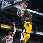 
              Indiana Pacers' Myles Turner (33) dunks against Houston Rockets' Christian Wood (35) during the second half of an NBA basketball game, Thursday, Dec. 23, 2021, in Indianapolis. (AP Photo/Darron Cummings)
            